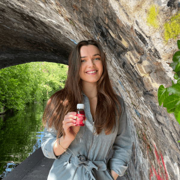 Katie Morley holds a Plenish Beet Balance shot